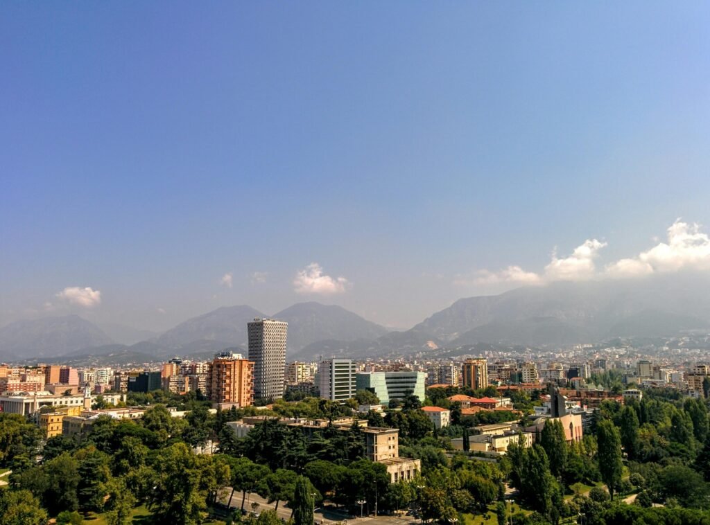 Grey Concrete Building in the Middle of the City Under Blue Sky